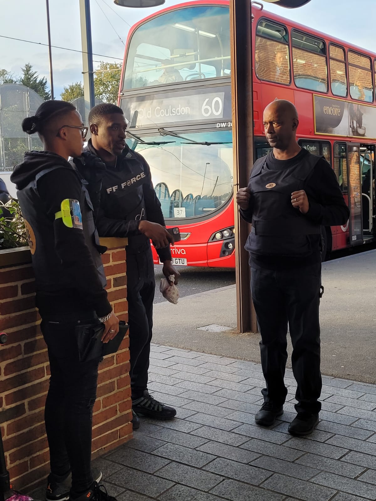 Rashell Ali Chowdhury of SouthGate Protection CIC standing and talking with two CCAG members during a community safety patrol